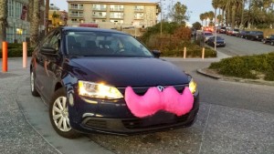 Lyft car with the signature pink mustache. This has become a popular mode of transportation for business travel.