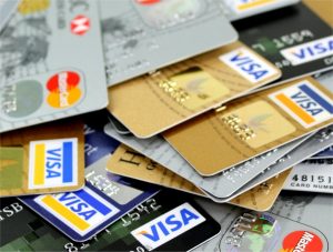 A messy stack of credit cards - Churning credit cards can damage your credit