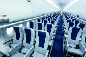 The seat you choose for your air travel says a lot about you. This is a picture of an empty SuperJet plane with blue seats and blue carpets.