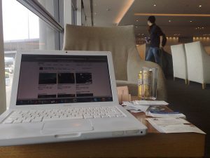 Business travel often means working in an airport between flights. This is a photo of a white MacBook Pro taken in the Hong Kong airport.