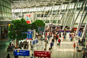 Picture of people walking through an airport. There are some ideal dates to book your holiday flights.