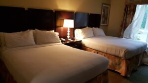 Two beds in a hotel room. There are a few ways you can make sure you get a good night's sleep on your next hotel stay.