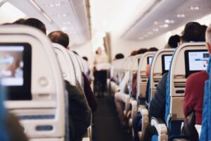 Inside an airplane looking down the main aisle. There are several rudeness prevention secrets you should know before you travel.