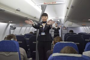 Flight attendants giving a flight safety demonstration.
