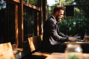 Photo of a bearded guy in a suit. Digital nomads and van life are a great way to reduce costs and find work-life balance.