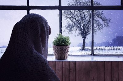 Someone looking outside during a snowy day. They have cabin fever bad!